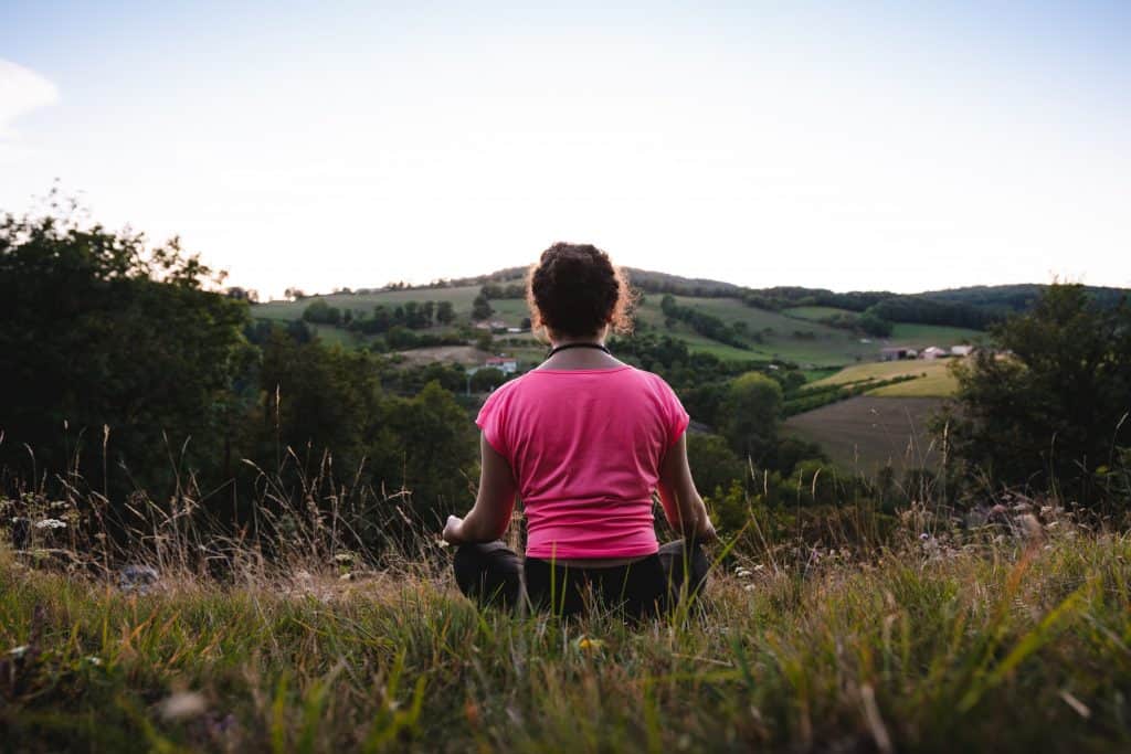 Photo by Léonard Cotte woman squatting in grass