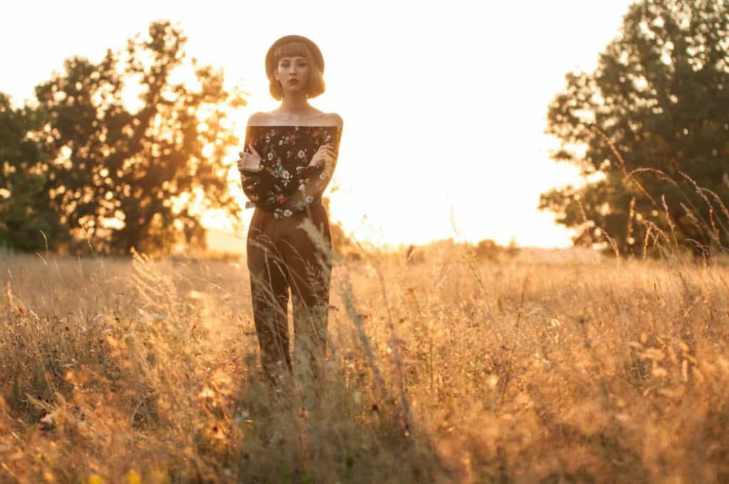 Photo by Marsel Mufaharov woman standing on grass field near trees