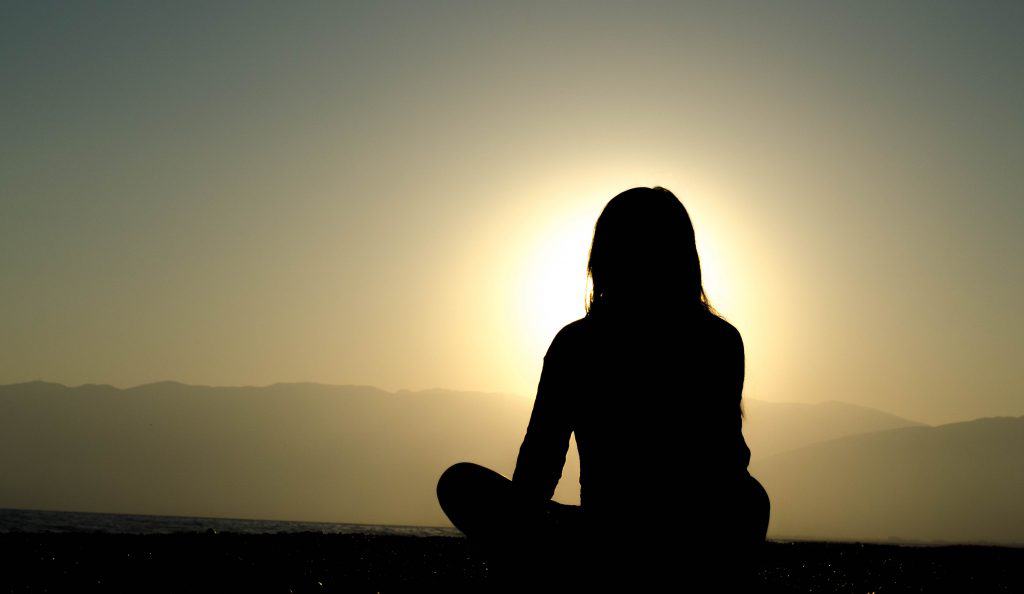 Photo by Dingzeyu Li woman sitting on sand